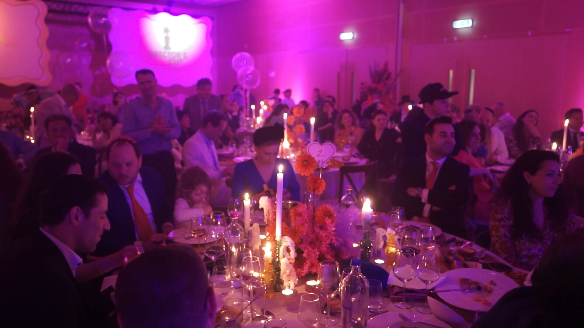 Festival guests gathered around candlelit gala tables.