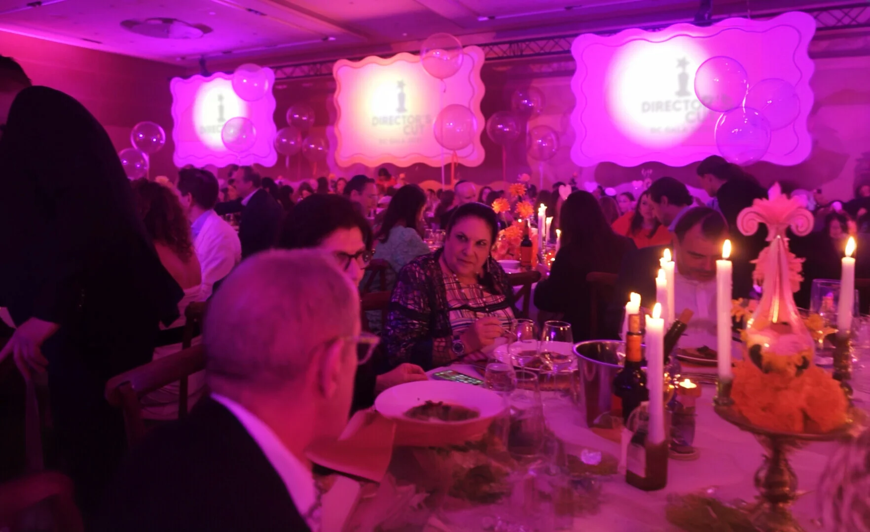Guests dining beneath projected Director’s Cut festival screens.