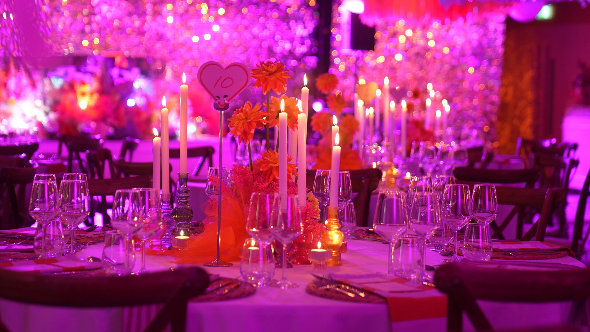 Director’s Cut gala table number ten with candles and orange flowers.